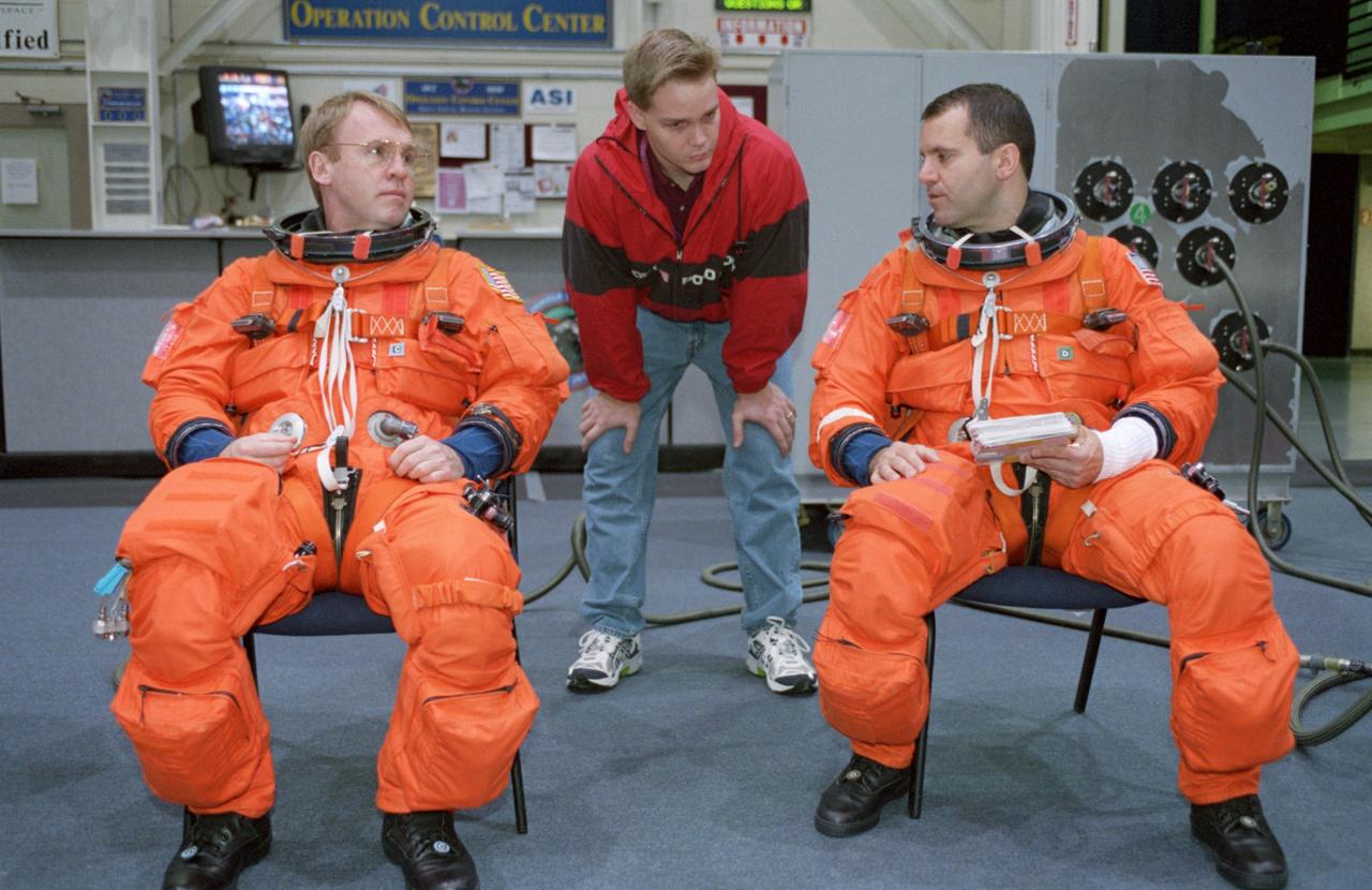 JSC2000-07442 (6 December 2000) --- Attired in training versions of their full-pressure launch and entry garments, two mission specialists for STS-102 are pictured prior to participating in  a simulation in the Crew Compartment Trainer (CCT-2) of the Systems Integration Facility at the Johnson Space Center (JSC).  They are astronauts Andrew S.W. Thomas (left) and Paul W. Richards.