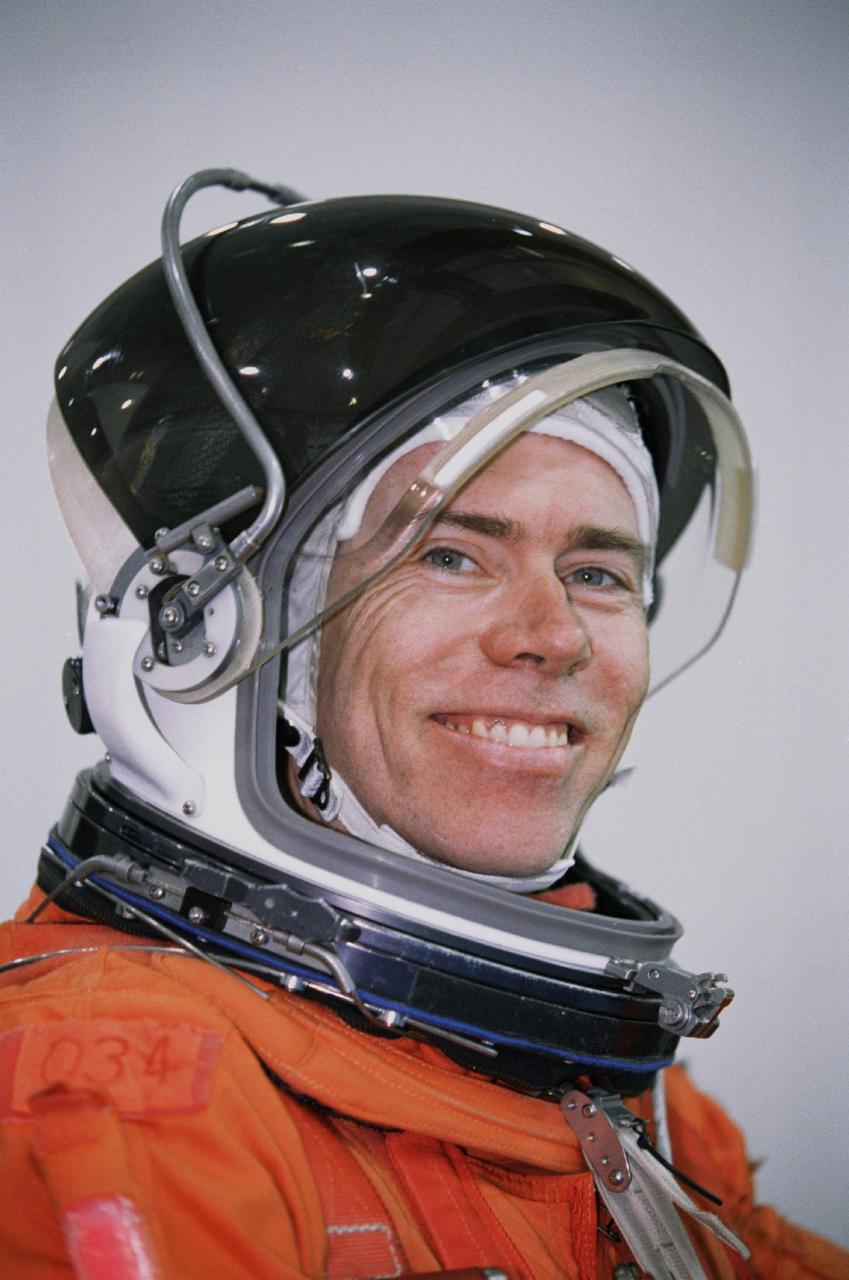 JSC2000-07466 (11 December 2000) --- Astronaut Daniel T. Barry, mission specialist, attired in a training version of the shuttle launch and entry garment, awaits the start of an emergency bailout training session at the Neutral Buoyancy Laboratory (NBL) near Johnson Space Center (JSC).