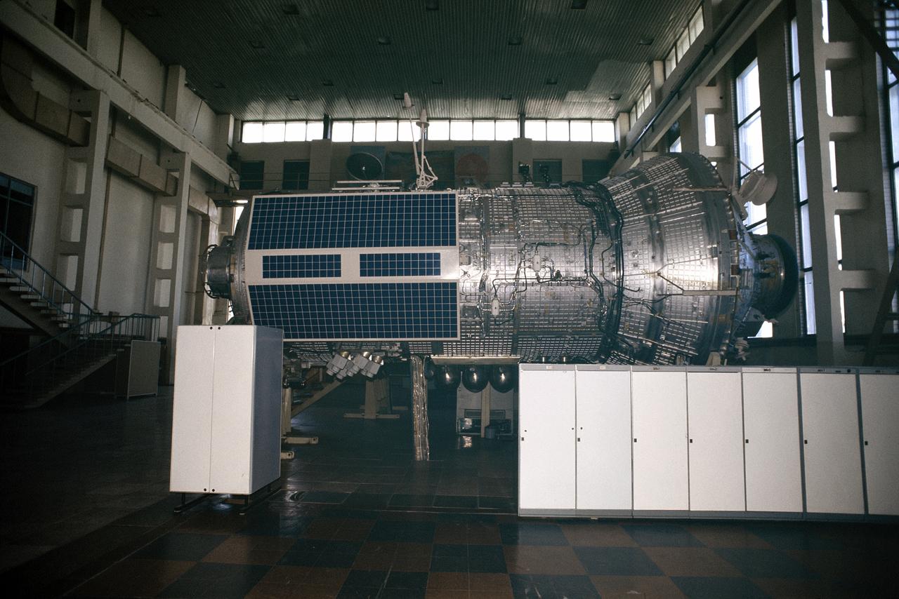 Photographic documentation of Expedition One crew in Russia with Service Module. Views include: The three crew members for ISS Expedition One train with computers on the trainer / mockup for the Zvezda Service Module. From the left are cosmonauts Yuri Gidzenko, Soyuz commander; and Sergei Krikalev, flight engineer; and astronaut William Shepherd, mission commander. The session took place at the Gagarin Cosmonaut Training Center in Russia (18628). View looking toward the hatch inside the Zvezda Service Module trainer / mockup at the Gagarin Cosmonaut Training Center in Russia (18629). A wide shot of the Zvezda Service Module trainer / mockup, with the transfer compartment in the foreground (18630). Side view of the Zvezda Service Module (18631). An interior shot of the Zarya / Functional Cargo Bay (FGB) trainer / mockup (18632). Astronaut Scott Kelly, director of operations - Russia, walks through a full scale trainer / mockup for the Zvezda Service Module at the Gagarin Cosmonaut Training Center in Russia (18633). Astronaut William Shepherd (right) mission commander for ISS Expedition One, and Sergei Krikalev, flight engineer, participate in a training session in a trainer / mockup of the Zvezda Service Module (18634).