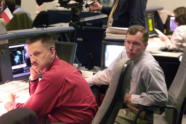JSC2000-E-22289 (8 September 2000) ---  Two astronauts at the Spacecraft Communicator (CAPCOM) console in Houston's Mission Control Center are about to witness the launch of the Space Shuttle Atlantis from the Kennedy Space Center (KSC) in Florida.  They are astronauts Christopher J. Loria (left) and Dominic L. Gorie.  Atlantis launched on schedule, at 8:46 a.m. (EDT), September 8, 2000, as the Johnson Space Center (JSC) flight control team took the baton from KSC's launch controllers.