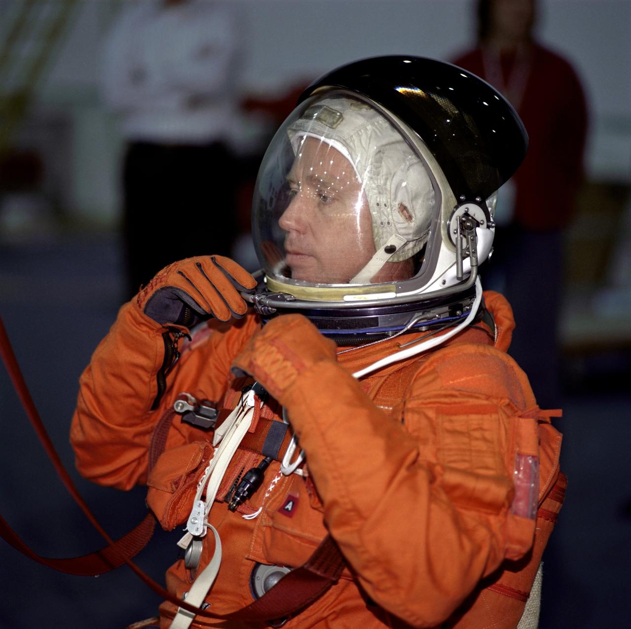 JSC2001-00008 (January 2001) --- Astronaut Steven W. Lindsey, STS-104 mission commander, adjusts his helmet as he prepares to participate in a simulation of a parachute drop into water during emergency bailout training at the Neutral Buoyancy Laboratory (NBL) near Johnson Space Center (JSC). Lindsey will join four other astronauts for a June mission with the International Space Station (ISS).