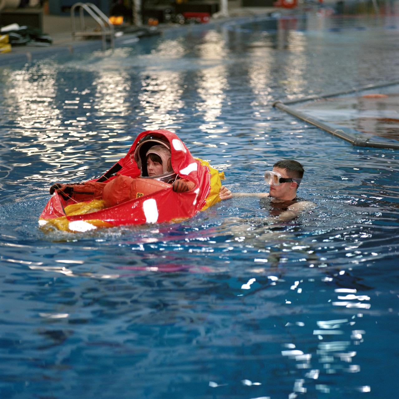 JSC2001-00021 (January 2001) --- Astronaut Janet L. Kavandi, STS-104 mission specialist, is assisted by a diver during an emergency bailout training session in the Neutral Buoyancy Laboratory (NBL) near Johnson Space Center (JSC).  Kavandi will join four other astronauts for a June mission with the International Space Station (ISS).