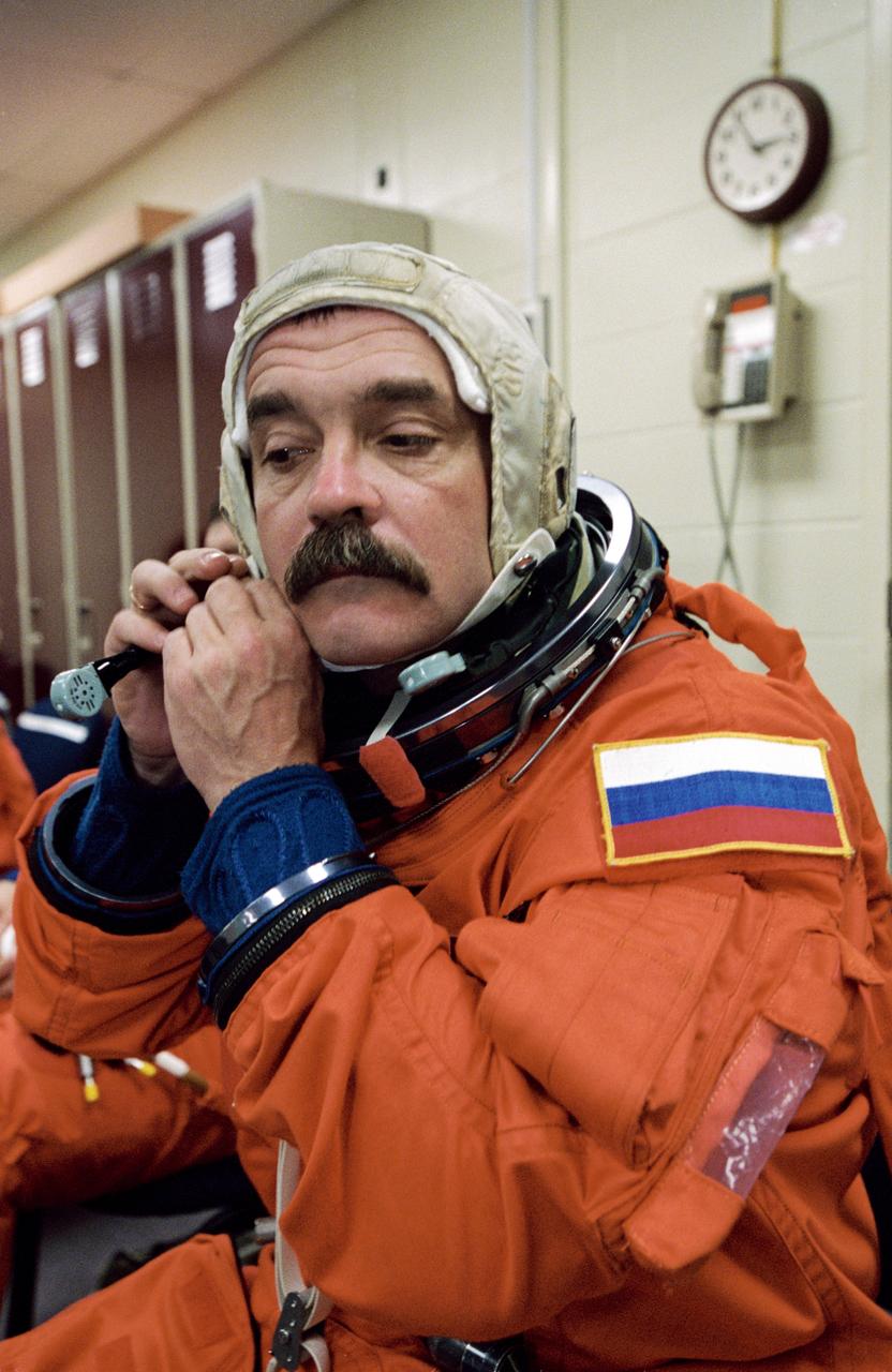 JSC2001-01125 (20 April 2001) --- Cosmonaut Mikhail Tyurin, Expedition Three flight engineer representing Rosaviakosmos, dons a training version of the full-pressure launch and entry suit prior to a training session in one of the trainer/mockups (out of frame) in the Johnson Space Center’s Systems Integration Facility.
