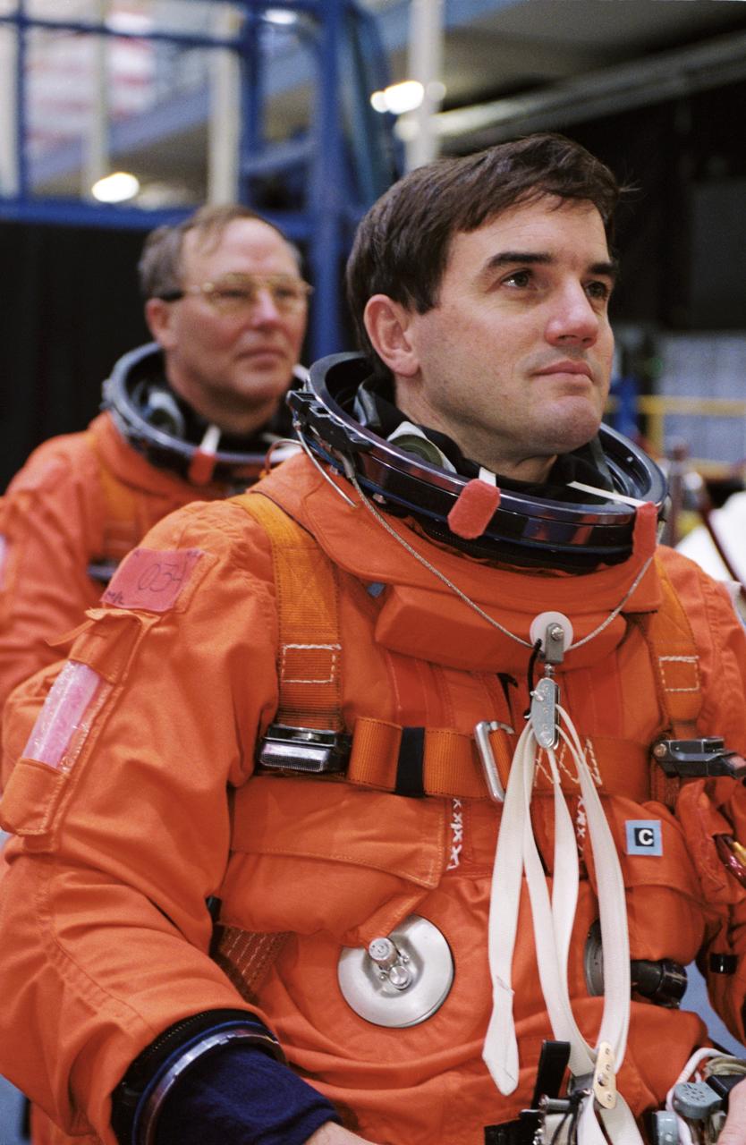 JSC2001-02173 (10 August 2001) --- Astronauts Rex J. Walheim (foreground) and Jerry L. Ross, both STS-110 mission specialists, wearing training versions of the full-pressure launch and entry suit, wait for a training and photo session to begin in the Space Vehicle Mockup Facility at the Johnson Space Center (JSC). STS-110 will be the 13th shuttle mission to visit the International Space Station (ISS).