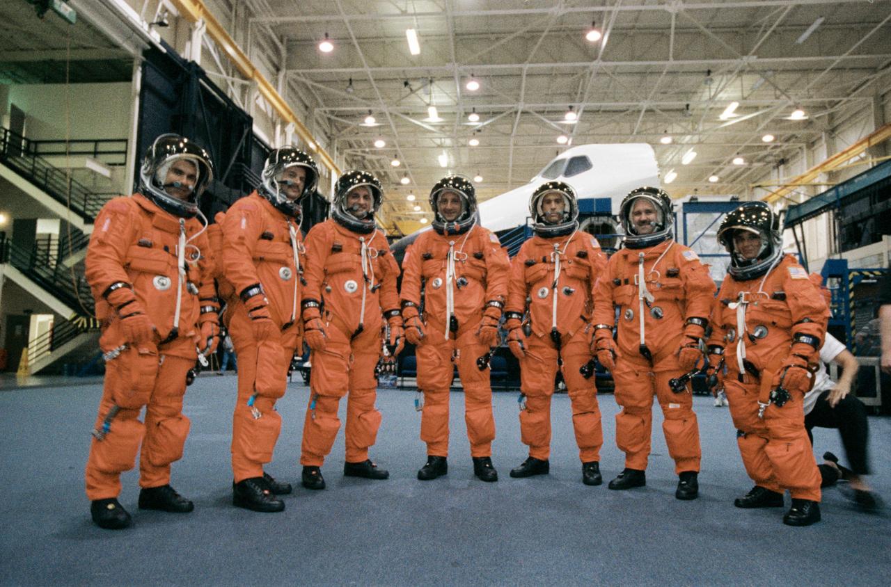 JSC2001-02205 (9 August 2001) --- The seven STS-109 crew members wait for a training and photo session to begin in the Space Vehicle Mockup Facility at the Johnson Space Center (JSC). From the left are astronauts Duane G. Carey and Scott D. Altman, pilot and mission commander, respectively, and Richard M. Linnehan, Michael J. Massimino, James H. Newman, John M. Grunsfeld, and Nancy J. Currie, all mission specialists. STS-109 will be the 108th shuttle flight and the fourth Hubble Space Telescope (HST) servicing mission.