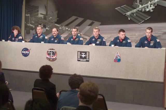 JSC2001-E-05523 (28 February 2001) ---  The STS-102 crew fields questions from various news media representatives at a press briefing at the Johnson Space Center (JSC).  From the right are astronauts James D. Wetherbee, mission commander; James M. Kelly, pilot; and Andrew S.W. Thomas, Paul W. Richards,  and cosmonaut Yury V. Usachev, James S. Voss and Susan J. Helms, all mission specialists.  Expedition Two commander Usachev, representing Rosaviakosmos, will join flight engineers Voss and Helms in the first crew exchange aboard the Earth-orbiting International Space Station (ISS).