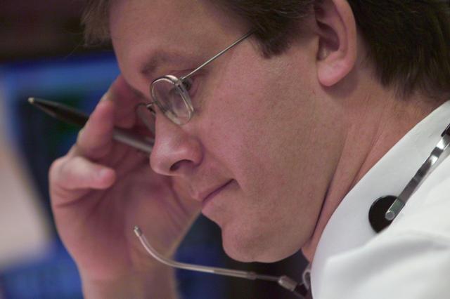 JSC2001-E-06200 (8 March 2001) ---  At his console in Houston's Mission Control Center, STS-102 lead flight director John Shannon, studies mission data on STS-102 launch day.