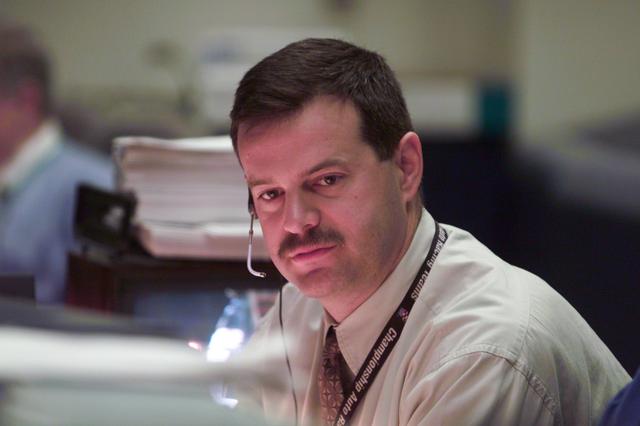 JSC2001-E-06203 (8 March 2001) --- At his console in Houston's Mission Control Center, astronaut Scott D. Altman, spacecraft communicator (CAPCOM), monitors weather data possibly affecting Discovery's pre-launch activities several hundred miles away in Florida on STS-102 launch day.