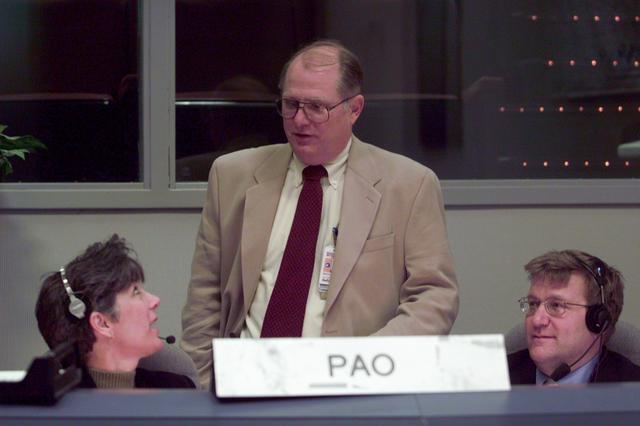 JSC2001-E-06205 (8 March 2001) ---  Eileen Hawley at the Public Affairs Officer (PAO) console poses a query to  Brock R. (Randy) Stone (center) of the Mission Operations Directorate (MOD) prior to the launch of STS-102.  Hawley  was the launch commentator for the Discovery mission. Daniel Carpenter, director of the Public Affairs Office, is at right.