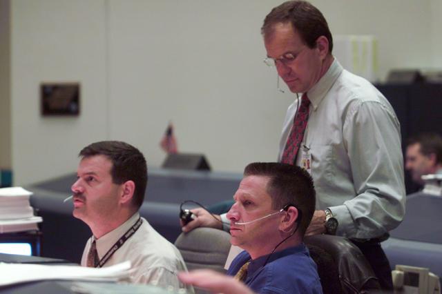JSC2001-E-06206 (8 March 2001) --- Pictured at the Spacecraft Communicator (CAPCOM) console in JSC's Mission Control Center are (from the left) astronauts Scott D. Altman, Christopher J. (Gus) Loria and Michael J. Bloomfield.  Altman and Bloomfield were checking into possible weather effects for the scheduled launch of the Space Shuttle Discovery.