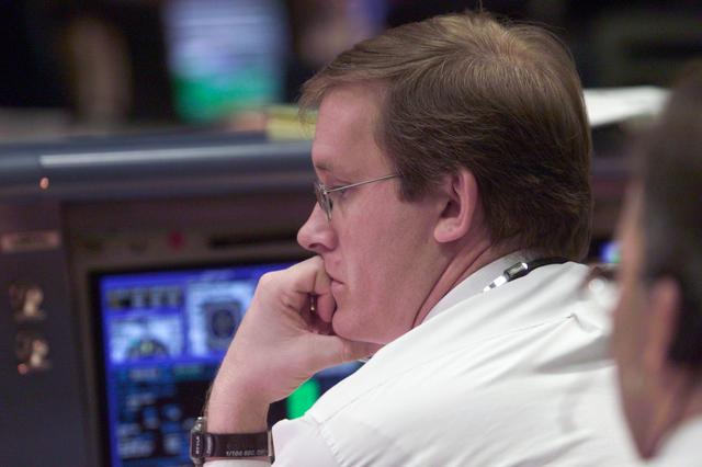 JSC2001-E-06217 (8 March 2001) ---  At his console in Houston's Mission Control Center, STS-102 lead flight director John Shannon studies mission data on STS-102 launch day.