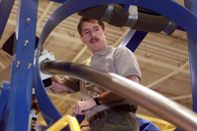 JSC2001-E-06401 (27 February 2001) --- Astronaut James F. Reilly, mission specialist, rehearses emergency egress procedures in the Systems Integration Facility at the Johnson Space Center (JSC). The long tube at left is a training version of the launch escape pole which is now carried onboard for all shuttle flights. The STS-104 mission to the International Space Station (ISS) represents the Space Shuttle Atlantis' first flight using a new engine and is targeted for a liftoff no earlier than June 14, 2001.