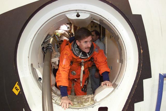 JSC2001-E-06422 (27 February 2001) --- Astronaut James F. Reilly, mission specialist, rehearses emergency egress procedures in the Systems Integration Facility at the Johnson Space Center (JSC). The long tube at left is a training version of the launch escape pole which is now carried onboard for all shuttle flights. The STS-104 mission to the International Space Station (ISS) represents the Space Shuttle Atlantis' first flight using a new engine and is targeted for a liftoff no earlier than June 14, 2001.