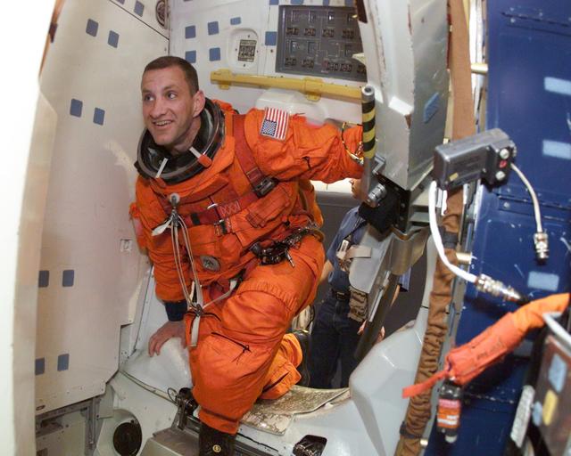 JSC2001-E-06424 (27 February 2001) --- Astronaut Charles O. Hobaugh, pilot, prepares to rehearse emergency egress during mission training in one of the high fidelity trainers/mockups in the Systems Integration Facility at Johnson Space Center (JSC). The STS-104 mission to the International Space Station (ISS) represents the Space Shuttle Atlantis' first flight using a new engine and is targeted for a liftoff no earlier than June 14, 2001.