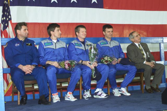 JSC2001-E-08317 (22 March 2001) ---  Members of the Expedition One crew  await opportunities to individually address a crowd gathered at Ellington Field to honor their return to Houston.  return.  Pictured from the left are cosmonaut Vasily Tsibliev, Deputy Director of the Gagarin Cosmonaut Training Center in Star City; cosmonaut  Sergei K. Krikalev, Expedition One flight engineer; astronaut William M. (Bill) Shepherd, mission commander; and Yuri P. Gidzenko, Soyuz commander; along with Joseph Rothenberg, NASA Associate Administrator for Space Flight.