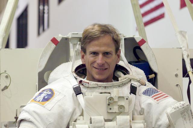 JSC2001-E-10911 (13 April 2001) --- Astronaut Michael L. Gernhardt, mission specialist, photographed in the training version of his Extravehicular Mobility Unit (EMU) space suit prior to being submerged in the waters of the Neutral Buoyancy Laboratory (NBL) at the Johnson Space Center (JSC). The STS-104 mission to the International Space Station (ISS) represents the Space Shuttle Atlantis' first flight using a new engine and is targeted for a liftoff no earlier than June 14, 2001.