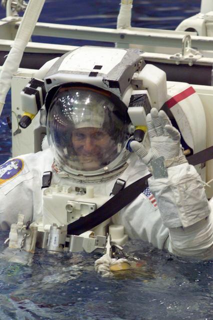 JSC2001-E-10920 (13 April 2001) --- Astronaut Michael L. Gernhardt, mission specialist, waves as he is submerged in the waters of the Neutral Buoyancy Laboratory (NBL) at the Johnson Space Center (JSC). The STS-104 mission to the International Space Station (ISS) represents the Space Shuttle Atlantis' first flight using a new engine and is targeted for a liftoff no earlier than June 14, 2001.