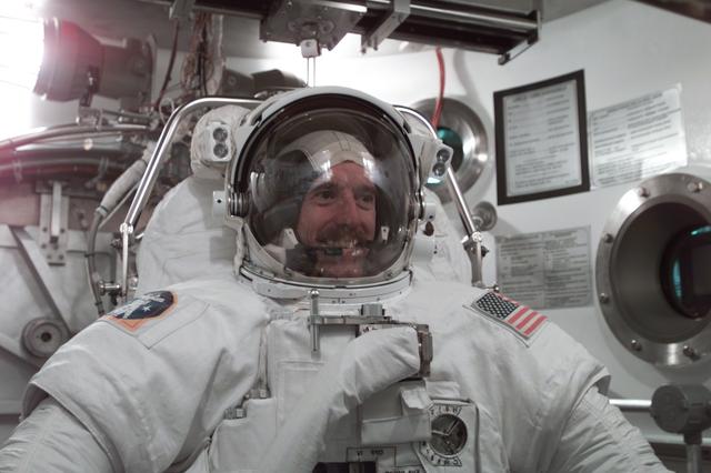 JSC2001-E-11697 (9 April 2001) ---  Astronaut James F. Reilly, STS-104 mission specialist, participates in an Extravehicular Mobility Unit (EMU) fit check in one of the chambers in the Crew Systems Laboratory at the Johnson Space Center (JSC).  The STS-104 mission to the International Space Station (ISS) represents the Space Shuttle Atlantis' first flight using a new engine and is targeted for a liftoff no earlier than June 14, 2001.