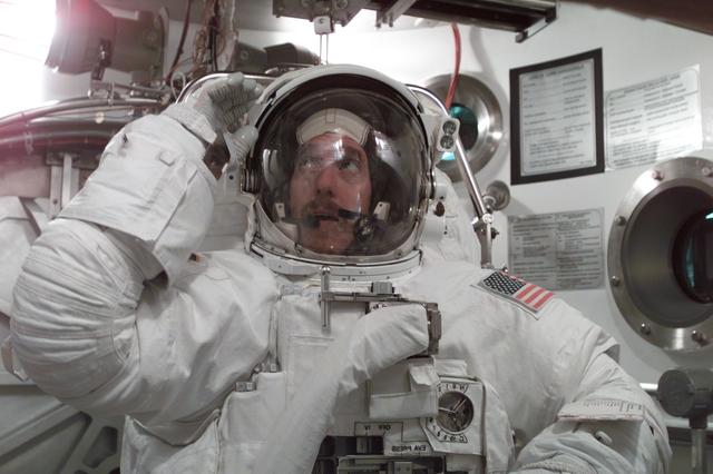 JSC2001-E-11699 (9 April 2001) ---  Astronaut James F. Reilly, STS-104 mission specialist, participates in an Extravehicular Mobility Unit (EMU) fit check in one of the chambers in the Crew Systems Laboratory at the Johnson Space Center (JSC).  The STS-104 mission to the International Space Station (ISS) represents the Space Shuttle Atlantis' first flight using a new engine and is targeted for a liftoff no earlier than June 14, 2001.