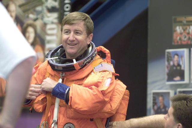 JSC2001-E-12451 (24 April 2001) --- Astronaut Frank L. Culbertson, Expedition Three commander, assisted by suit technicians (out of frame), dons a training version of the full-pressure launch and entry suit prior to a training session in one of the trainer/mockups (out of frame) in the Systems Integration Facility at Johnson Space Center (JSC).
