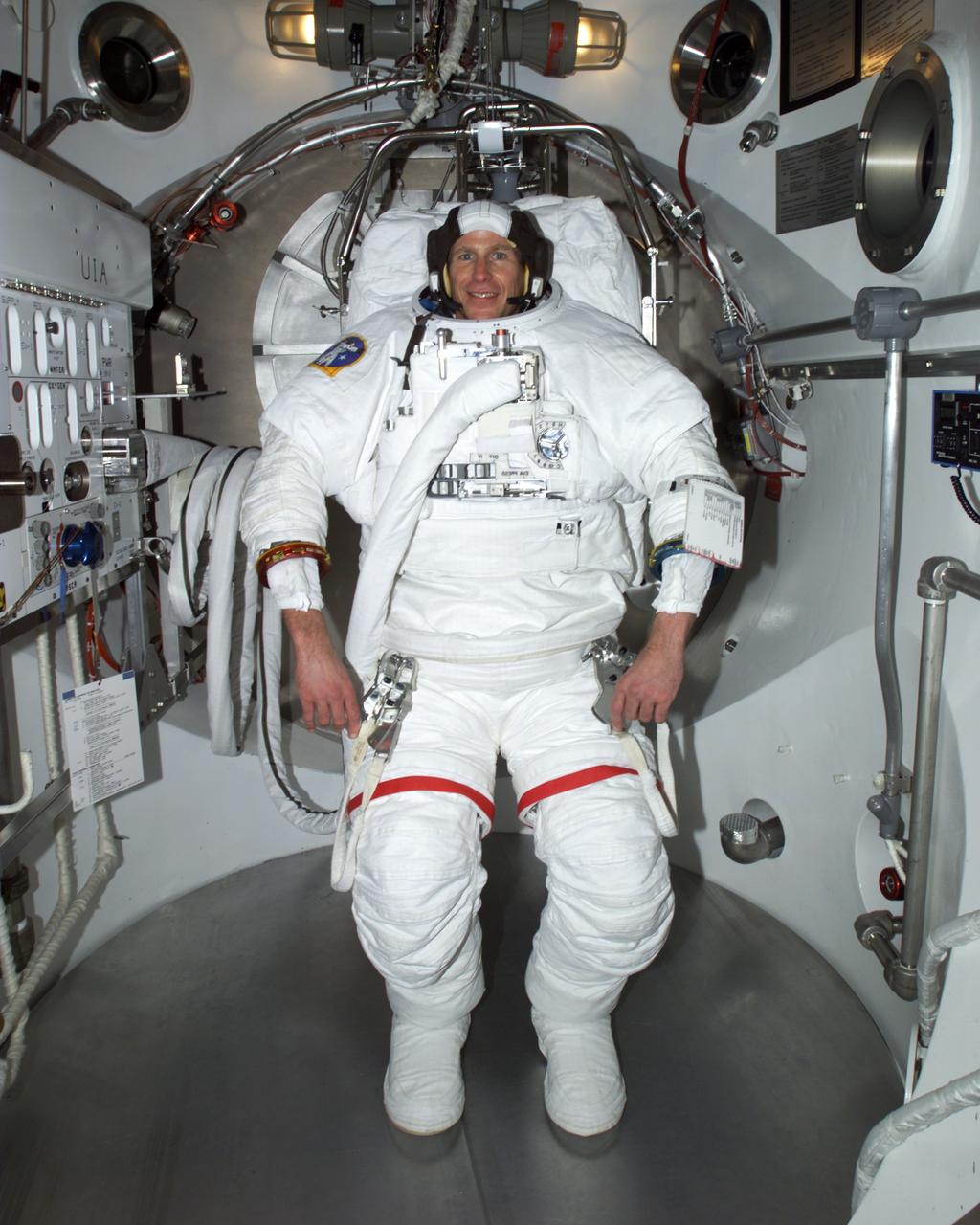 JSC2001-E-16629 (14 May 2001) --- Astronaut Michael L. Gernhardt, STS-104 mission specialist, participates in an Extravehicular Mobility Unit (EMU) fit check in one of the airlock chambers in the Crew Systems Laboratory at the Johnson Space Center (JSC).  The STS-104 mission to the International Space Station (ISS) represents the Space Shuttle Atlantis' first flight using a new engine and is targeted for a liftoff in the summer of this year.