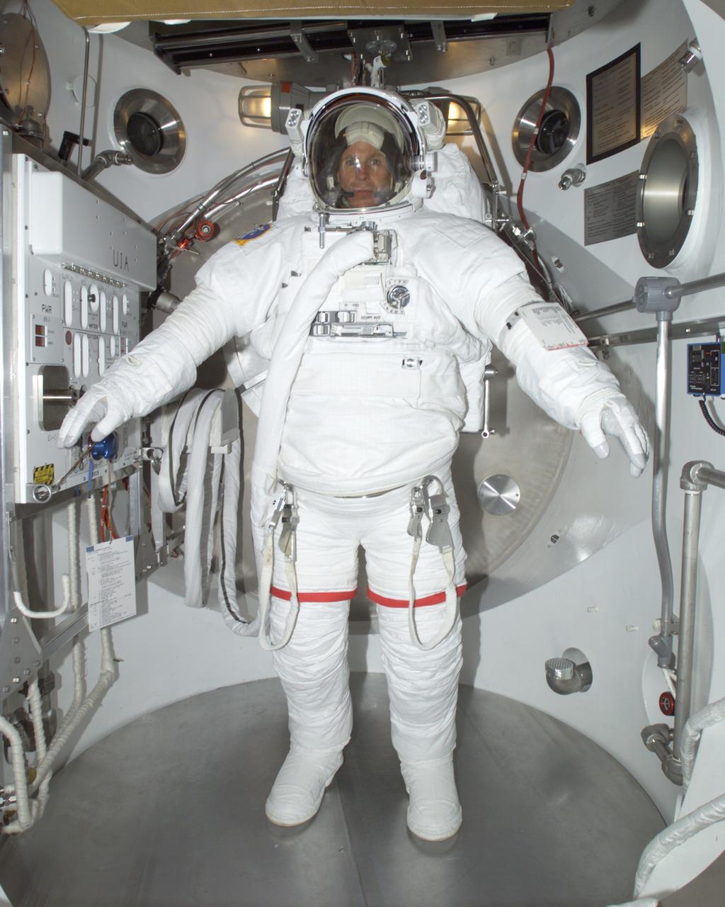 JSC2001-E-16632 (14 May 2001) --- Astronaut Michael L. Gernhardt, STS-104 mission specialist, participates in an Extravehicular Mobility Unit (EMU) fit check in a Space Station Airlock Test Article (SSATA)in the Crew Systems Laboratory at the Johnson Space Center (JSC).  The STS-104 mission to the International Space Station (ISS) represents the Space Shuttle Atlantis' first flight using a new engine and is targeted for a liftoff in the summer of this year.
