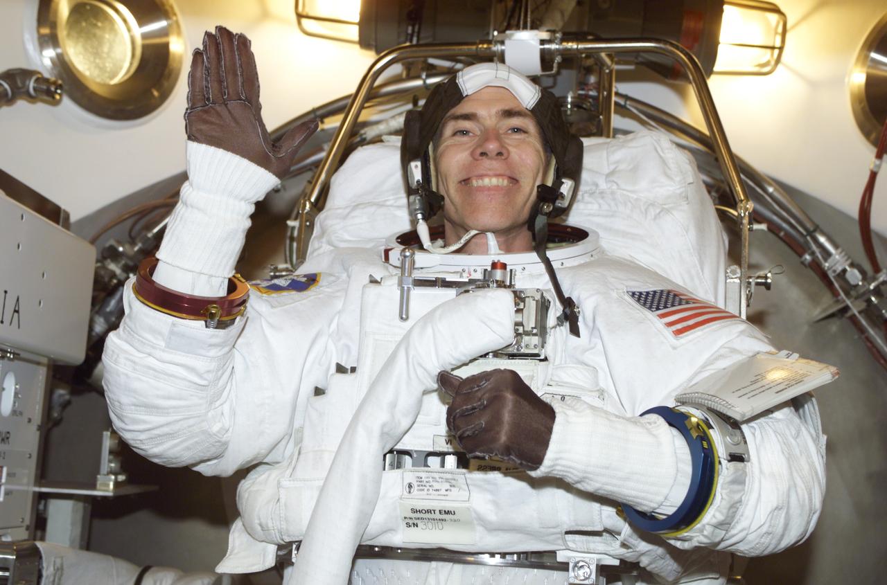JSC2001-E-18350 (5 June 2001) --- Astronaut Daniel T. Barry, STS-105 mission specialist, is photographed during an Extravehicular Mobility Unit (EMU) fit check in a Space Station Airlock Test Article (SSATA) in the Crew Systems Laboratory at the Johnson Space Center (JSC).