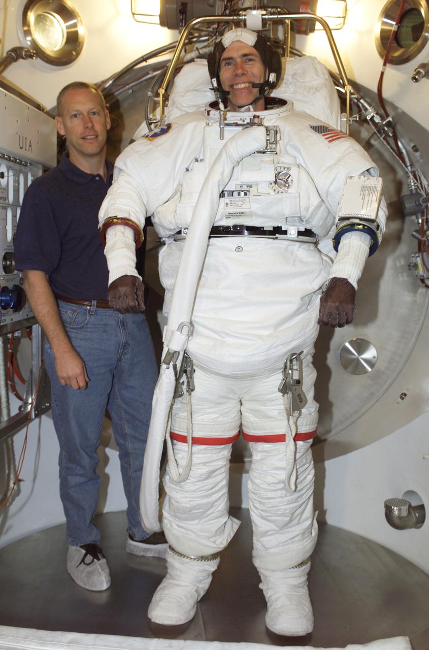 JSC2001-E-18351 (5 June 2001) --- Astronauts Patrick G. Forrester (left) assists Daniel T. Barry, both STS-105 mission specialists, in an Extravehicular Mobility Unit (EMU) fit check in a Space Station Airlock Test Article (SSATA) in the Crew Systems Laboratory at the Johnson Space Center (JSC).