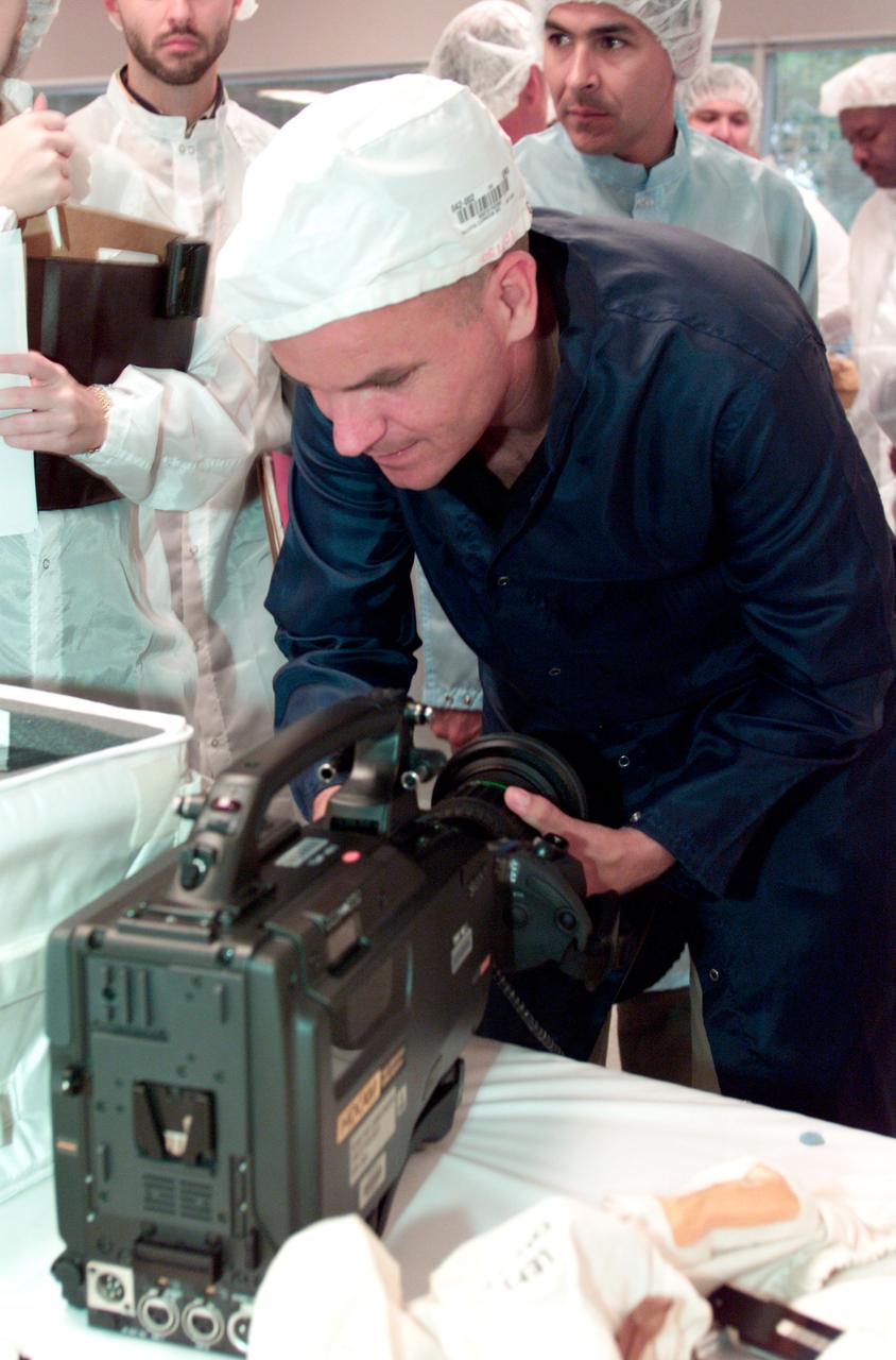 JSC2001-E-19233 (12 June 2001) --- Astronaut Frederick W. Sturckow, STS-105 pilot, inspects an IMAX camera during a crew equipment bench review in an offsite facility near Johnson Space Center (JSC).