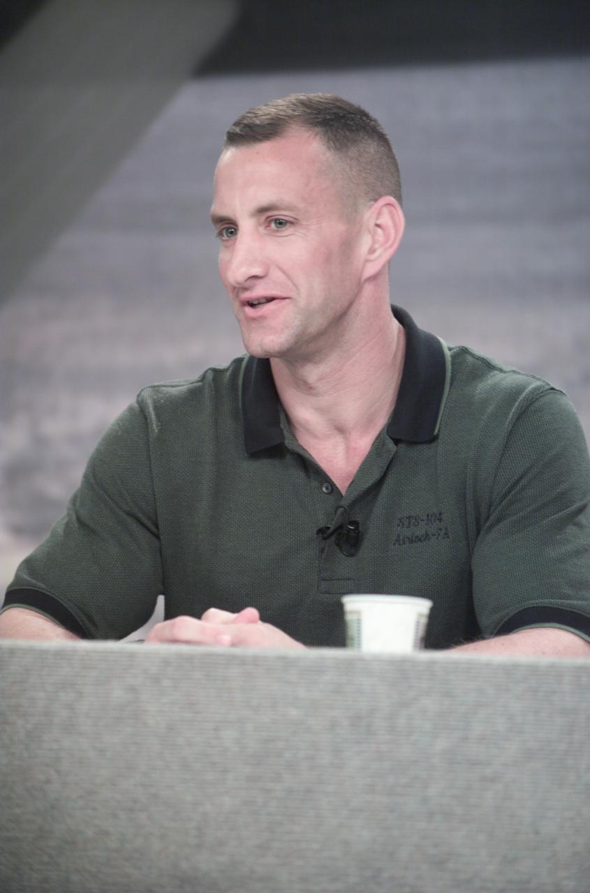 JSC2001-E-19303 (25 June 2001) --- Astronaut Charles O. Hobaugh, STS-104 mission specialist, listen to a question from a news media representative during a pre-flight press conference at Johnson Space Center (JSC).