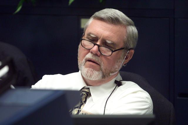 JSC2001-E-21331 (12 July 2001) --- Alan L. (Lee) Briscoe, chief engineer for the Mission Operations Directorate, looks over pre-flight data at the MOD console in the shuttle flight control room (WFCR) in Houston's Mission Control Center (MCC) during the countdown leading up to the launch of the Space Shuttle Atlantis and the beginning of the STS-104 mission.