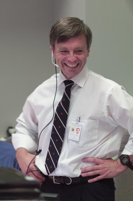 JSC2001-E-21573 (16 July 2001) --- Astronaut Robert B. Thirsk of the Canadian Space Agency (CSA), STS-104 spacecraft communicator (CAPCOM), finds a moment of levity while working at his console in Houston's Mission Control Center (MCC).
