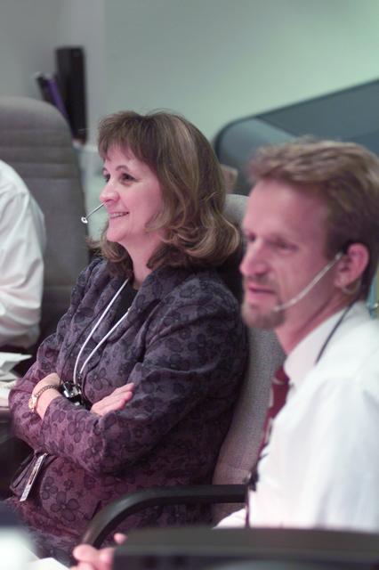 JSC2001-E-21574 (16 July 2001) --- ISS Orbit 1 flight director Sally Davis and Derek Hassman monitor International Space Station (ISS) issues at their consoles in the blue flight control room (BFCR) in Houston's Mission Control Center (MCC).  At the time this photo was taken, the STS-104 and Expedition Two crews had joined efforts to perform a number of station-related tasks.