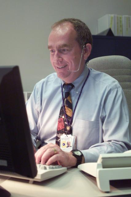 JSC2001-E-21583 (16 July 2001) --- Flight controller James M. Duncan inputs data into his computer at his console in Houston's Mission Control Center (MCC) during the STS-104 mission.