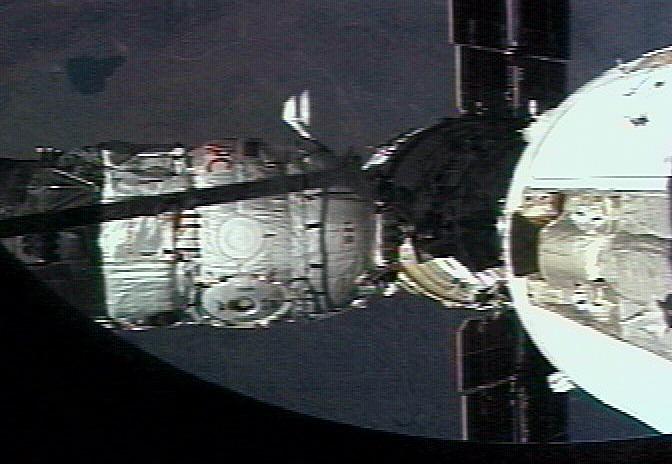 JSC2001-E-27145 (16 September 2001) --- The Russian Docking Compartment, named Pirs (the Russian word for pier), docks with the International Space Station (ISS).  One of the Expedition Three crew members, using a video camera, recorded the rendezvous and docking from onboard the orbital outpost. The Pirs vehicle was launched on September 14, 2001, and docking occurred on September 16.