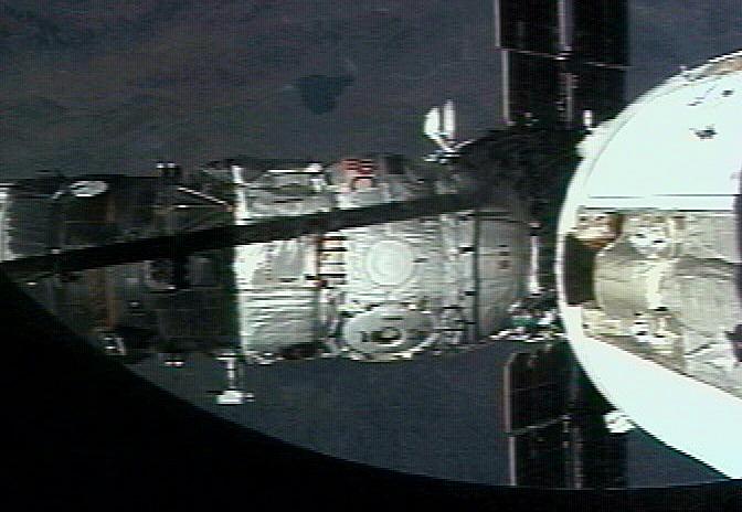 JSC2001-E-27146 (16 September 2001) --- The Russian Docking Compartment, named Pirs (the Russian word for pier), docks with the International Space Station (ISS).  One of the Expedition Three crew members, using a video camera, recorded the rendezvous and docking from onboard the orbital outpost. The Pirs vehicle was launched on September 14, 2001 and docking occurred on September 16.