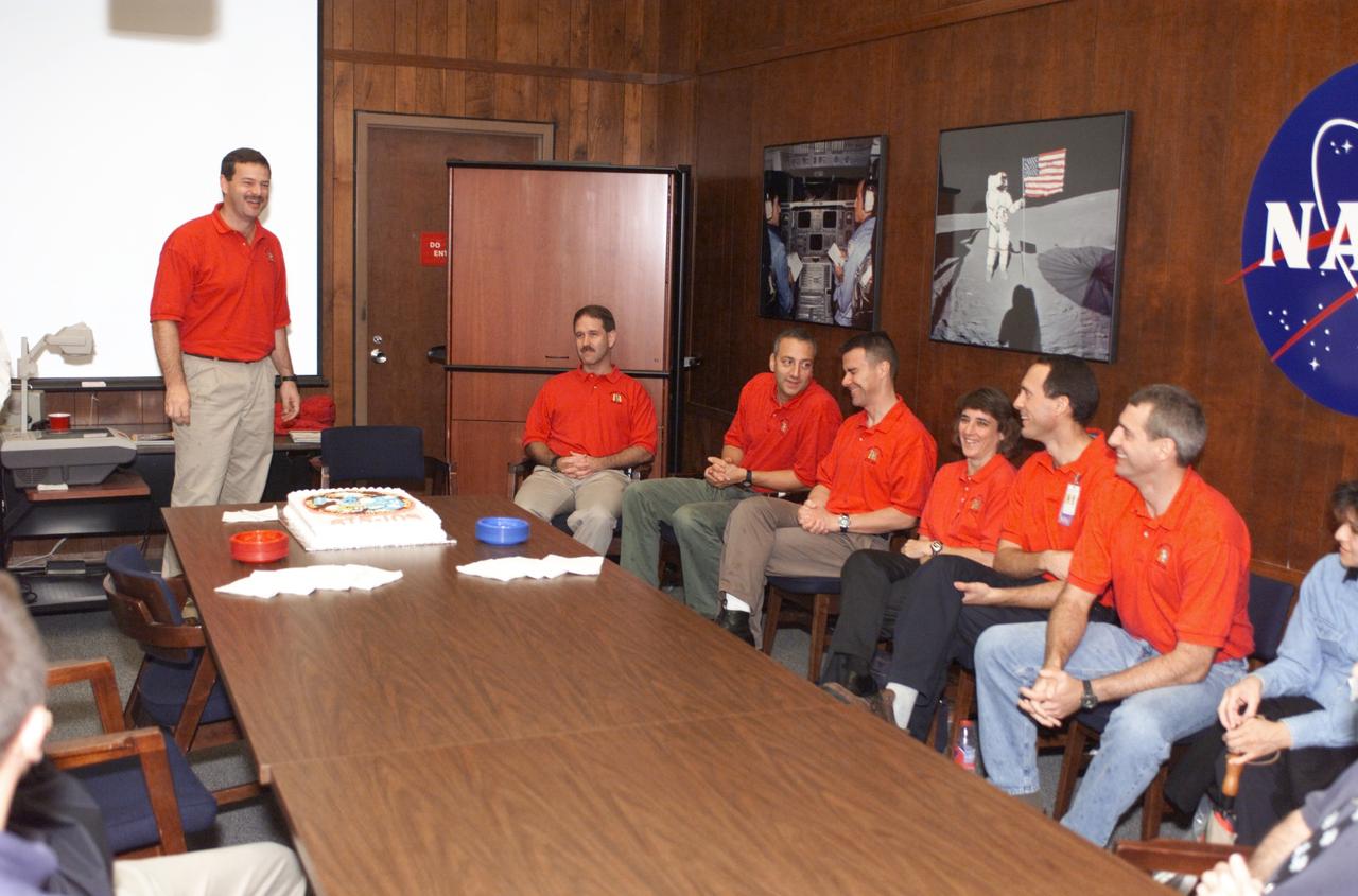 JSC2001-E-44844 (December 2001) --- The STS-109 crew members pause from their mission training for a cake cutting ceremony in the Jake Garn Simulation and Training Facility at the Johnson Space Center (JSC). Standing is astronaut Scott D. Altman, mission commander. Seated from left to right are astronauts John M. Grunsfeld, payload commander; Michael J. Massimino, mission specialist; Duane G. Carey, pilot; along with Nancy J. Currie, James H. Newman, and Richard M. Linnehan, mission specialists.