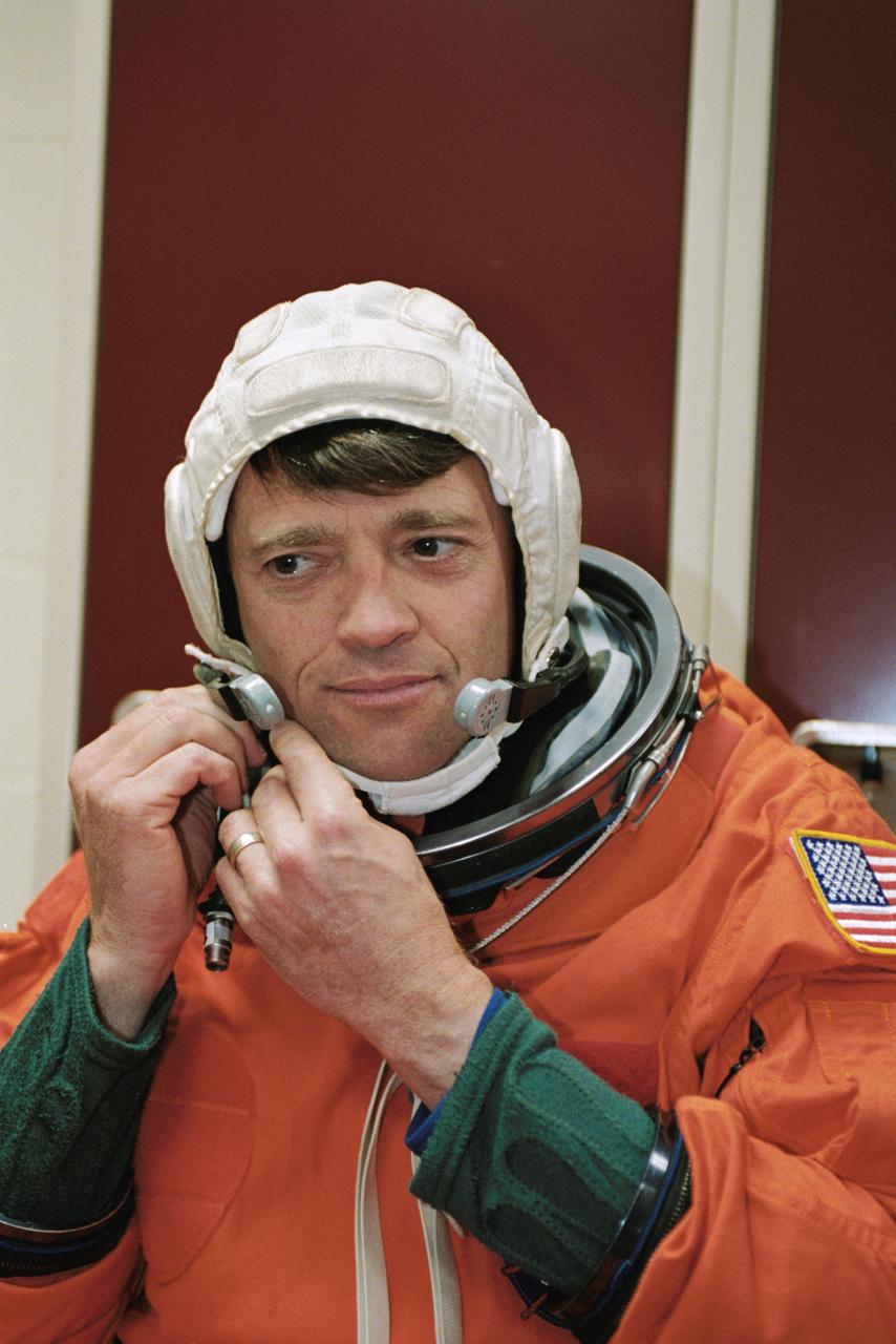 JSC2002-00792 (12 April 2002) --- Astronaut Jeffrey S. Ashby, STS-112 mission commander,  dons a training version of the full-pressure launch and entry suit, prior to the start of a photo and training session in the Space Vehicle Mockup Facility at the Johnson Space Center (JSC). STS-112 will be the 15th shuttle mission to visit the International Space Station (ISS).