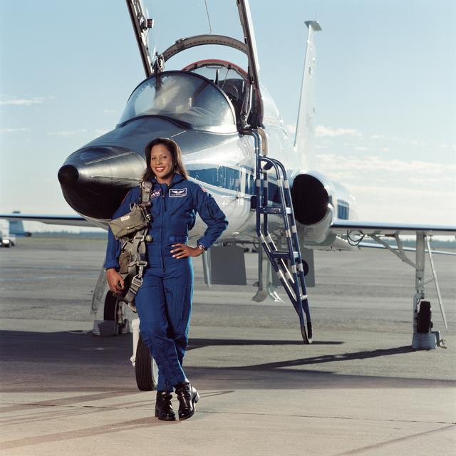 NASA image: Joan Higginbotham posing in front of a T-38 aircraft and sitting in a T-38 cockpit