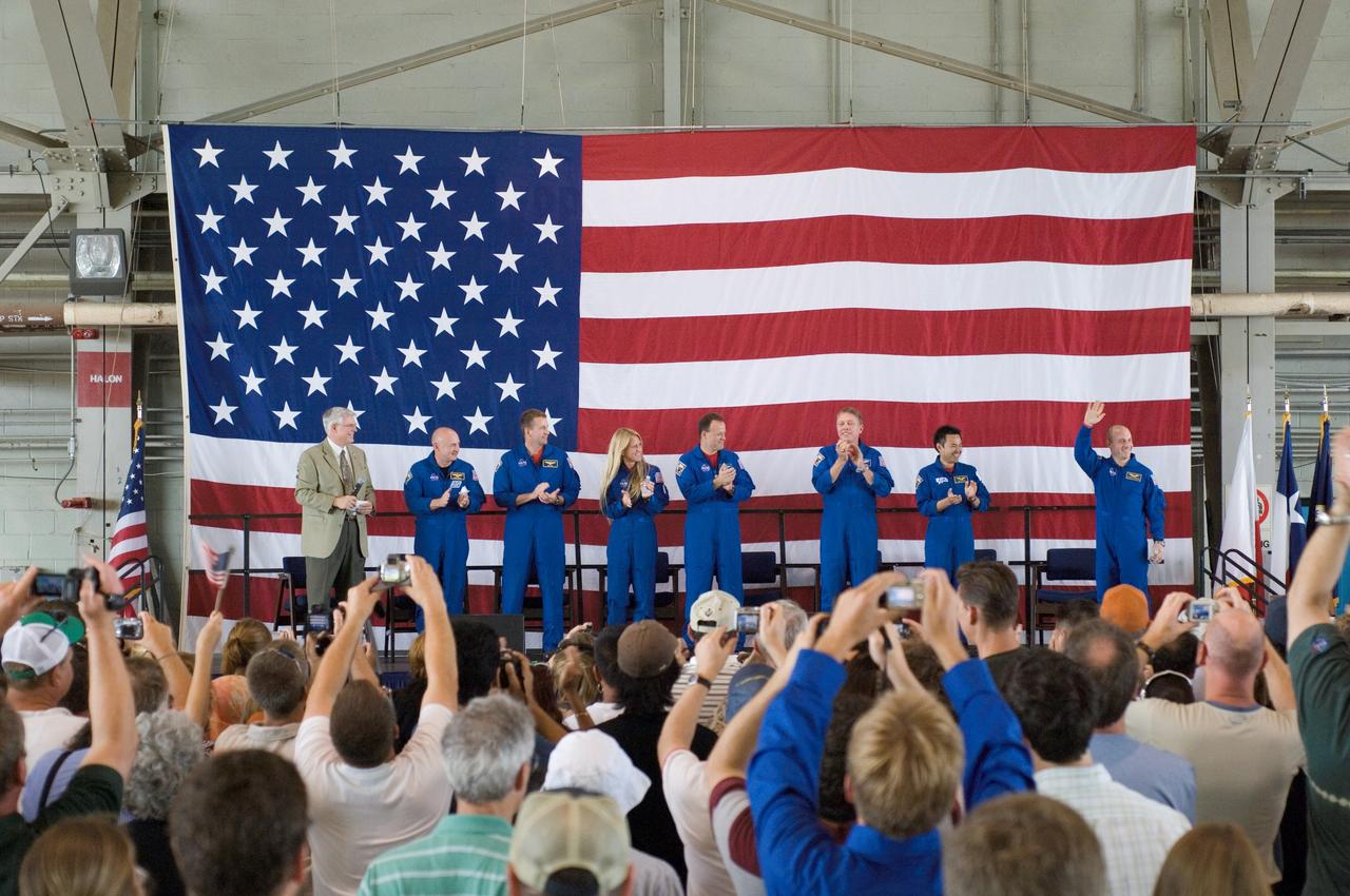 JSC2008-E-047111 (15 June 2008) --- The STS-124 crewmembers were welcomed home to Houston June 15, 2008, following the landing of Space Shuttle Discovery in Florida on June 14. NASA's Johnson Space Center (JSC) director Michael L. Coats (far left) introduced the crew to a large crowd on hand at Ellington Field near JSC. From the second left are NASA astronauts Mark Kelly, commander; Ken Ham, pilot; Karen Nyberg, Ron Garan, Mike Fossum, Japan Aerospace Exploration Agency astronaut Akihiko Hoshide and NASA astronaut Garrett Reisman, all mission specialists.