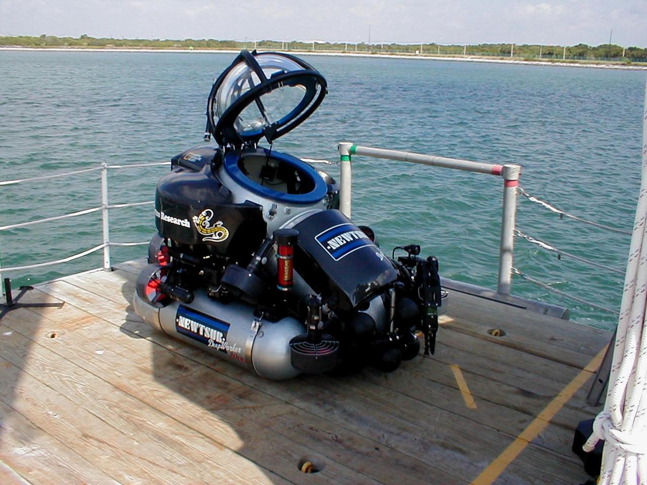 KENNEDY SPACE CENTER, FLA. -- The one-man submarine dubbed DeepWorker 2000 sits on the deck of Liberty Star, one of two KSC solid rocket booster recovery ships. The sub is being tested on its ability to duplicate the sometimes hazardous job United Space Alliance (USA) divers perform to recover the expended boosters in the ocean after a launch. The boosters splash down in an impact area about 140 miles east of Jacksonville and after recovery are towed back to KSC for refurbishment by the specially rigged recovery ships. DeepWorker 2000 will be used in a demonstration during retrieval operations after the upcoming STS-101 launch. The submarine pilot will demonstrate capabilities to cut tangled parachute riser lines using a manipulator arm and attach a Diver Operator Plug to extract water and provide flotation for the booster. DeepWorker 2000 was built by Nuytco Research Ltd., North Vancouver, British Columbia. It is 8.25 feet long, 5.75 feet high, and weighs 3,800 pounds. USA is a prime contractor to NASA for the Space Shuttle program