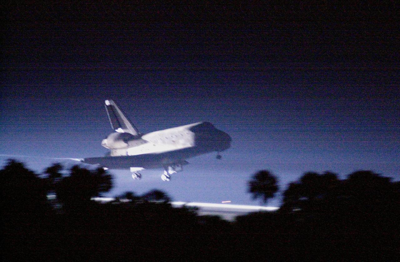 KENNEDY SPACE CENTER, Fla. -- Landing lights illuminate the night sky as Space Shuttle Atlantis approaches touchdown on KSC's Shuttle Landing Facility Runway 15 to complete the 9-day, 20-hour, 9-minute-long STS-101 mission. At the controls are Commander James D. Halsell Jr. and Pilot Scott "Doc" Horowitz. Also onboard the orbiter are Mission Specialists Mary Ellen Weber, James S. Voss, Jeffrey N. Williams, Susan J. Helms and Yury Usachev of Russia. The crew is returning from the third flight to the International Space Station. This was the 98th flight in the Space Shuttle program and the 21st for Atlantis, also marking the 51st landing at KSC, the 22nd consecutive landing at KSC, and the 29th in the last 30 Shuttle flights. Main gear touchdown was at 2:20:17 a.m. EDT, landing on orbit 155 of the mission. Nose gear touchdown was at 2:20:30 a.m. EDT, and wheel stop at 2:21:19 a.m. EDT