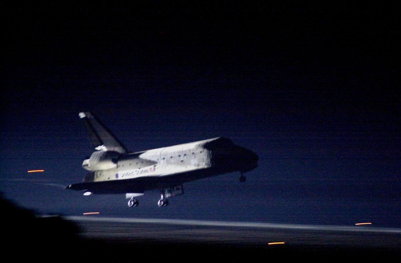KENNEDY SPACE CENTER, Fla. -- Space Shuttle Atlantis glows from the landing lights as it nears touchdown on KSC’s Shuttle Landing Facility Runway 15 to complete the 9-day, 20-hour, 9-minute-long STS-101 mission. At the controls are Commander James D. Halsell Jr. and Pilot Scott "Doc" Horowitz. Also onboard the orbiter are Mission Specialists Mary Ellen Weber, James S. Voss, Jeffrey N. Williams, Susan J. Helms and Yury Usachev of Russia. The crew is returning from the third flight to the International Space Station. This was the 98th flight in the Space Shuttle program and the 21<sup>st</sup> for Atlantis, also marking the 51st landing at KSC, the 22nd consecutive landing at KSC, and the 29th in the last 30 Shuttle flights. Main gear touchdown was at 2:20:17 a.m. EDT, landing on orbit 155 of the mission. Nose gear touchdown was at 2:20:30 a.m. EDT, and wheel stop at 2:21:19 a.m. EDT