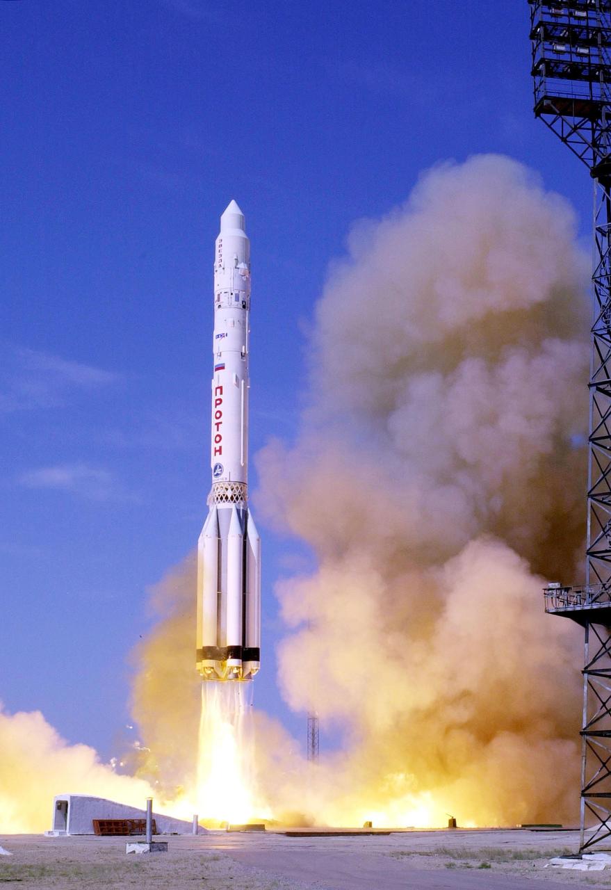  A Russian 3-stage Proton rocket blasts into the sky at 12:56 a.m. EDT with the Russian-built Zvezda module in a successful launch from Baikonur Cosmodrome, Kazakhstan. Zvezda is the primary Russian contribution to the International Space Station, serving as the early Station living quarters. It will also provide early propulsive attitude control and reboost capabilities and be the main docking port for Russian Progress cargo resupply vehicles. The third Station component, Zvezda will dock by remote control with the already orbiting Zarya and Unity modules at an altitude of about 245 by 230 statute miles. <i>(Image taken with Nikon D1 digital camera.)</i