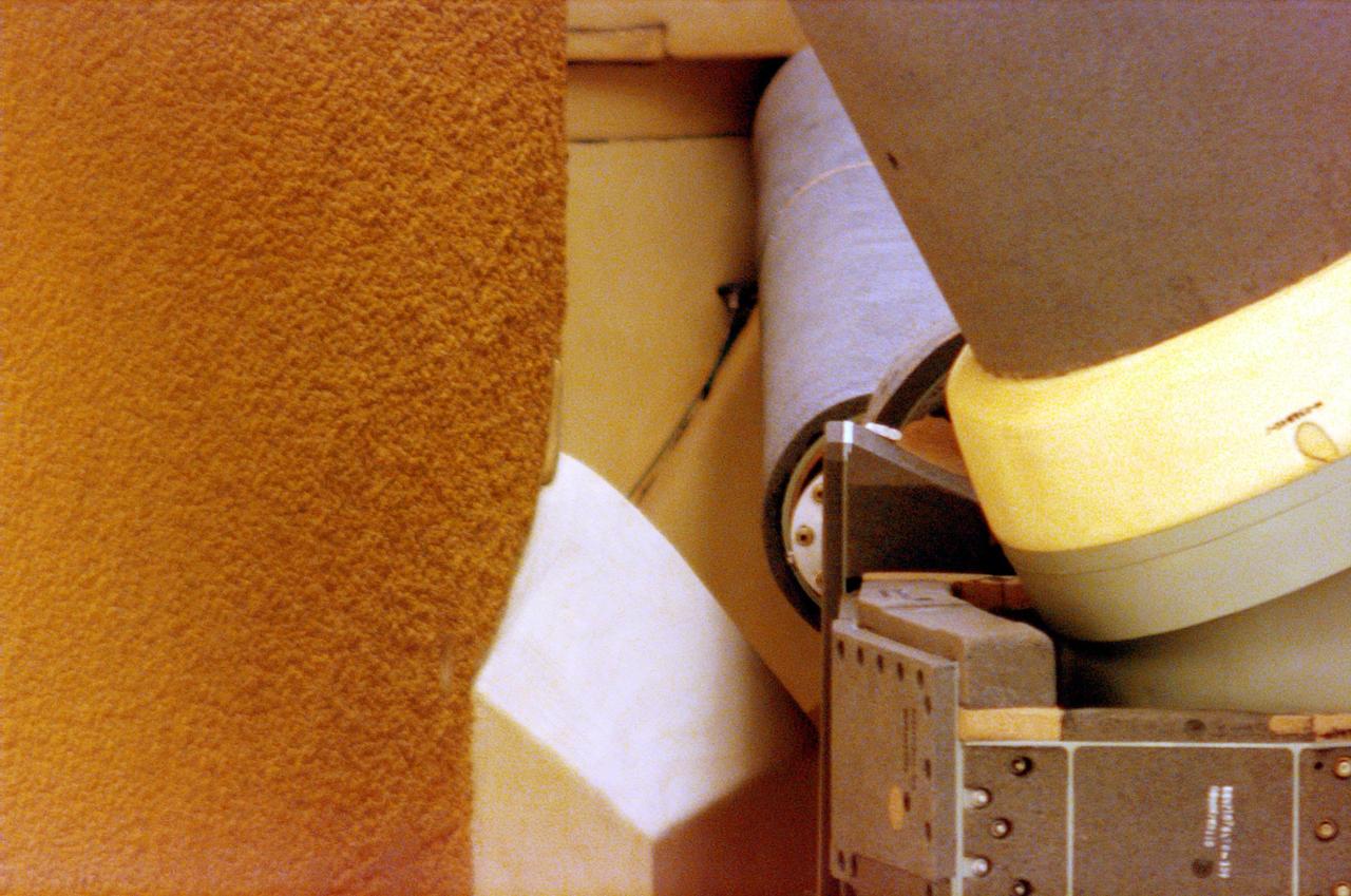 A locking pin can be seen in the background, almost as a shadow, next to the orbiter aft ET attachment. Locking pins are used to secure handrails on the platforms while work is being performed. The misplaced pin was noticed during an inspection prior to launch, causing the decision to scrub about 90 minutes before liftoff. Launch was rescheduled for Oct. 11 at 7:17 p.m