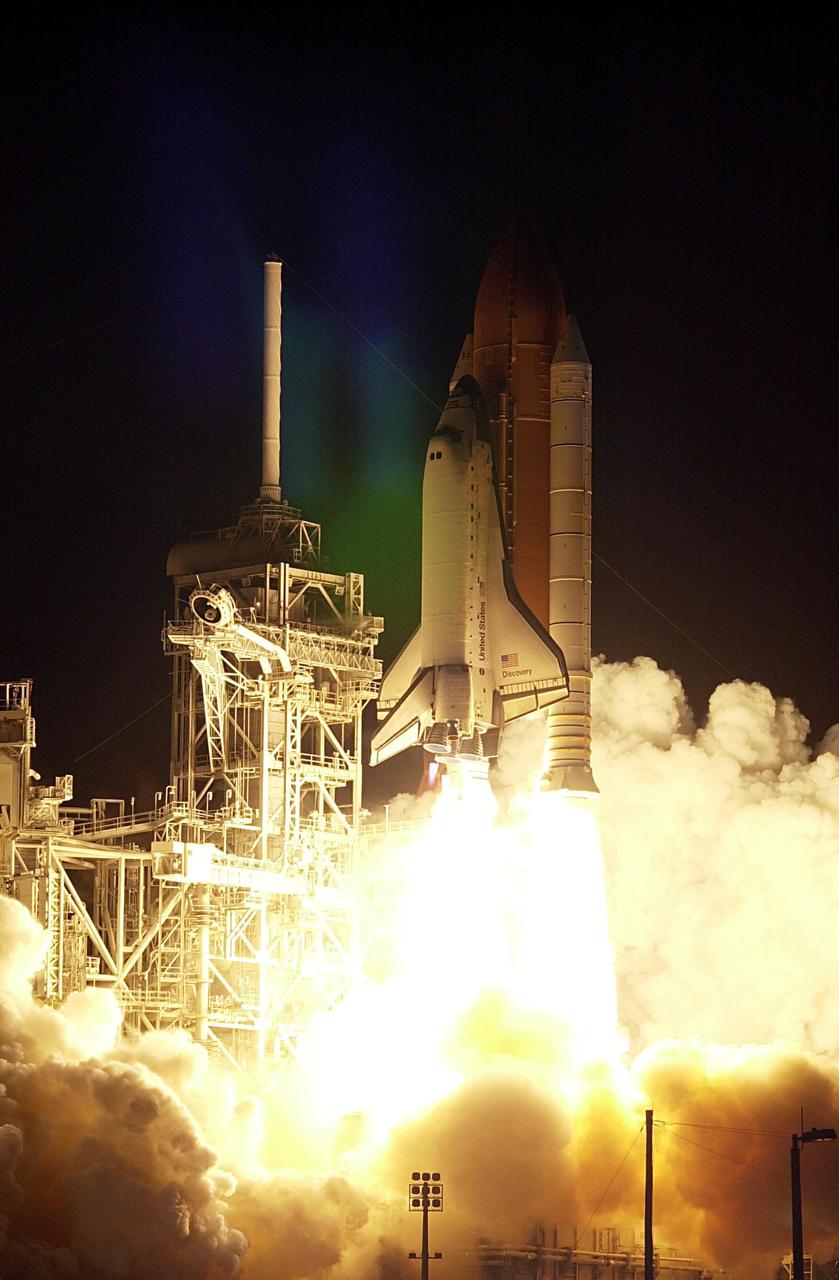KENNEDY SPACE CENTER, FLA. -- Space Shuttle Discovery hurtles into the night sky, trailing a tail of fire from the solid rocket boosters, after a perfect on-time launch at 7:17 p.m. EDT. The launch of mission STS-92 carries a crew of seven on a construction flight to the International Space Station. Discovery also carries a payload that includes the Integrated Truss Structure Z-1, first of 10 trusses that will form the backbone of the Space Station, and the third Pressurized Mating Adapter that will provide a Shuttle docking port for solar array installation on the sixth Station flight and Lab installation on the seventh Station flight. Discovery’s landing is expected Oct. 22 at 2:10 p.m. EDT.; <i>[Photo taken with Nikon D1 camera.]</i