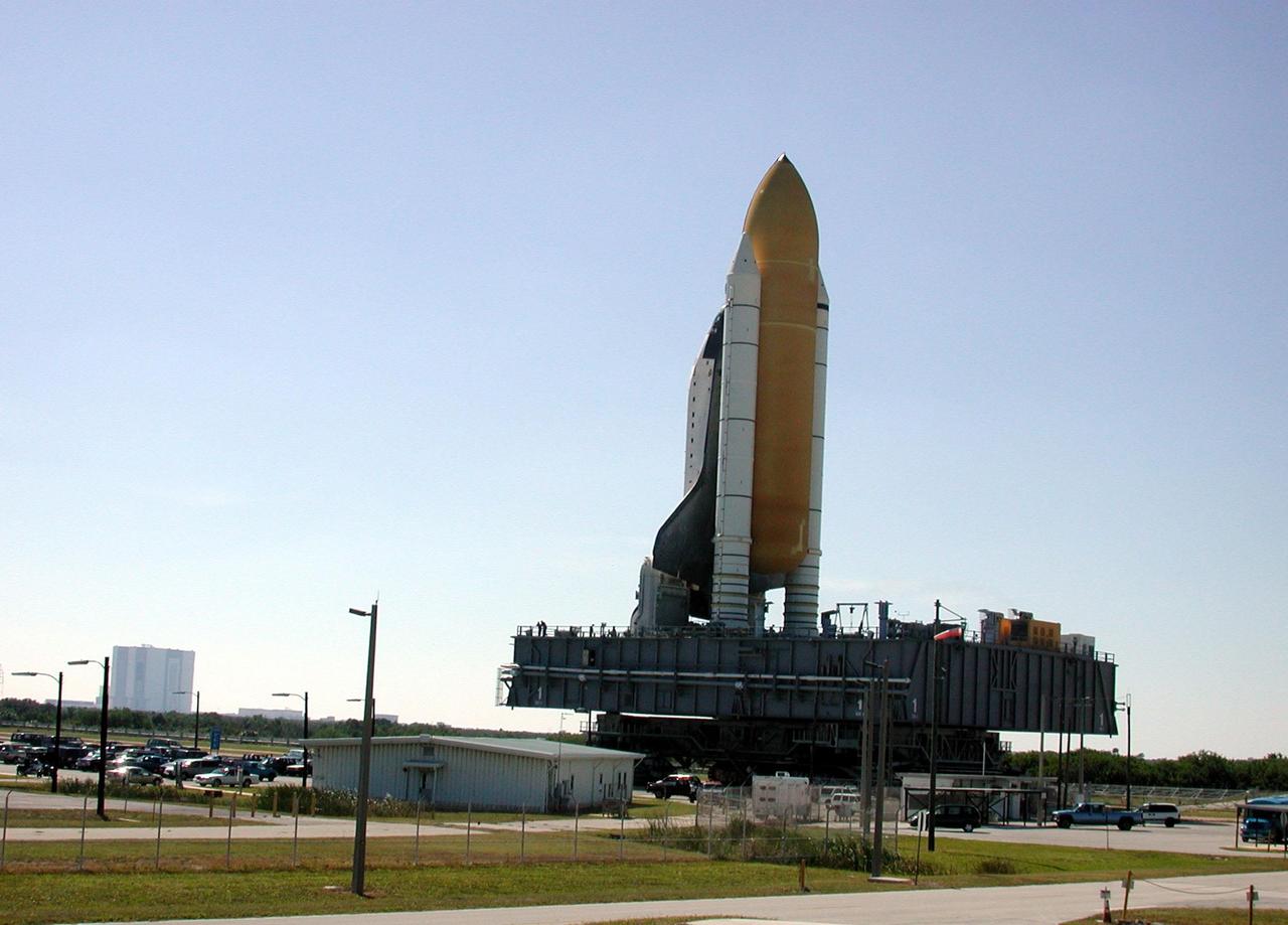 KENNEDY SPACE CENTER, FLA. -- Space Shuttle Endeavour is nearly through the gate on its backward trek from Launch Pad 39B. A broken cleat on the crawler-transporter forced the reverse movement so the cleat could be repaired before moving up the incline to the top of the pad. Endeavour is scheduled to be launched Nov. 30 at 10:01 p.m. EST on mission STS-97, the sixth construction flight to the International Space Station. Its payload includes the P6 Integrated Truss Structure and a photovoltaic (PV) module, with giant solar arrays that will provide power to the Station. The mission includes two spacewalks to complete the solar array connections