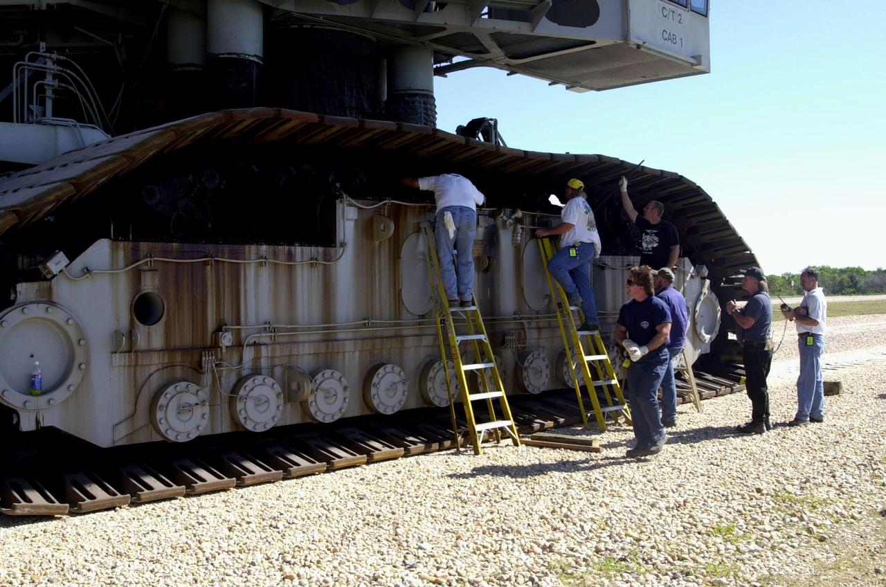 A repair crew works to repair the broken cleat on the crawler-transporter, found as it was moving up the incline on Launch Pad 39B. The Shuttle retreated to level ground so the broken cleat could be repaired. Endeavour is scheduled to be launched Nov. 30 at 10:01 p.m. EST on mission STS-97, the sixth construction flight to the International Space Station. Its payload includes the P6 Integrated Truss Structure and a photovoltaic (PV) module, with giant solar arrays that will provide power to the Station. The mission includes two spacewalks to complete the solar array connections