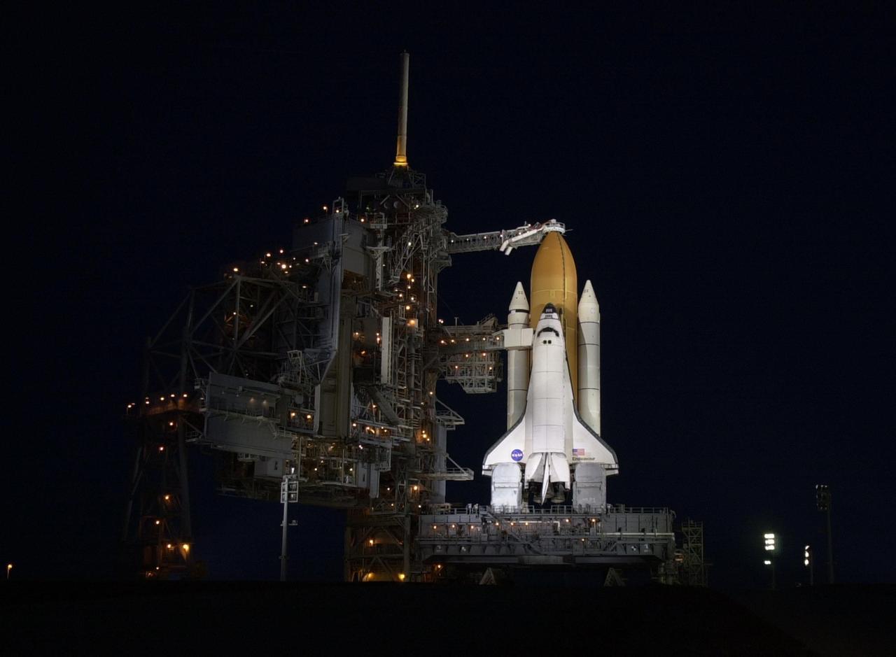After rollback of the Rotating Service Structure, Space Shuttle Endeavour is spotlighted against the still-black sky of pre-dawn. At the top of the external tank is the Gaseous Oxygen Vent Arm and its vent hood, known as the “beanie cap.” The hood is raised to clear the external tank 2.5 minutes before launch. Endeavour is targeted for launch Nov. 30 at about 10:06 p.m. EST on mission STS-97. In the background, the sky prepares for dawn. The mission to the International Space Station carries the P6 Integrated Truss Segment containing solar arrays and batteries that will be temporarily installed to the Unity connecting module by the Z1 truss, recently delivered to and installed on the Station on mission STS-92. The two solar arrays are each more than 100 feet long. They will capture energy from the sun and convert it to power for the Station. Two spacewalks will be required to install the solar array connections