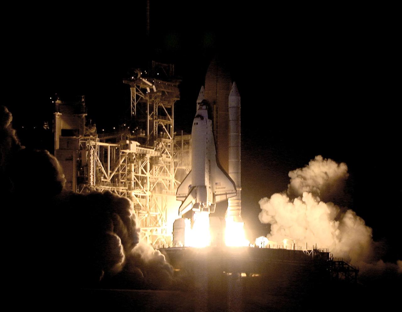 KENNEDY SPACE CENTER, Fla. -- In a perfect liftoff at 10:06:01 p.m. EST, Space Shuttle Endeavour, with its crew of five, roars into space in a burst of light. This sixth construction flight to the International Space Station is transporting the P6 Integrated Truss Structure that comprises Solar Array Wing-3 and the Integrated Electronic Assembly, to provide power to the Space Station. The 11-day mission includes two spacewalks to complete the solar array connections. Endeavour is expected to land Dec. 11 at 6:19 p.m. EST